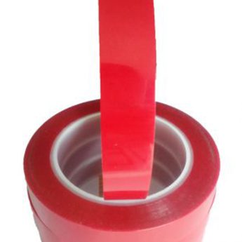 A red roll of tape is in the middle of a cylinder.